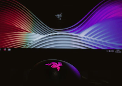 A sleek digital screen displaying colorful graphics at a busy trade show.
