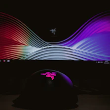 A sleek digital screen displaying colorful graphics at a busy trade show.