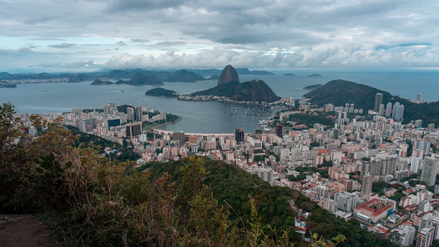 Aerial view of Sugarloaf Mountain rising from Guanabara Bay, with Rio's coastline curving beneath it