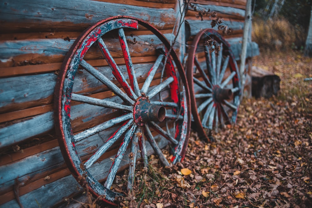 two carriage wheel beside wall