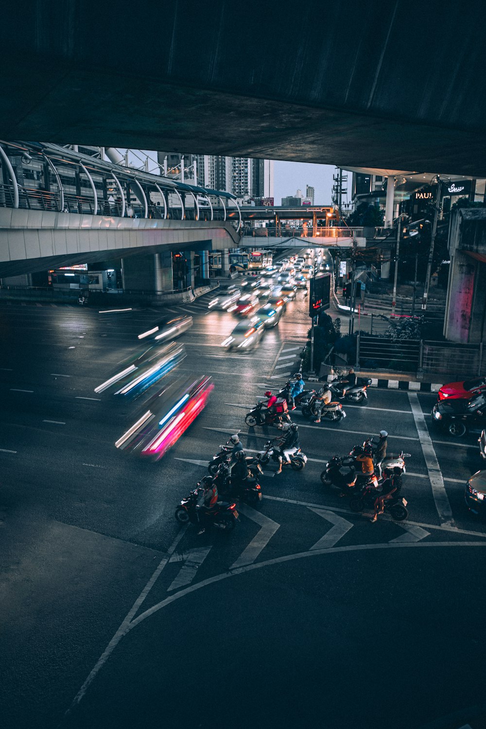 time lapse photography of vehicles passing by a road