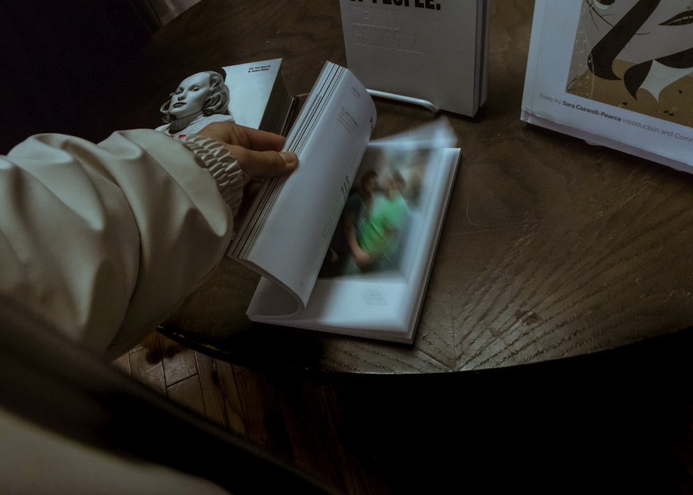 person scanning pages of a book