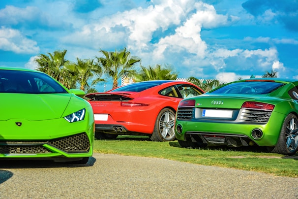 A stunning sunset backdrop highlighting a collection of luxury cars.
