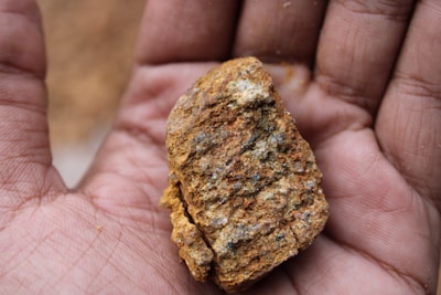 Close-up of hands holding rich mineral ore freshly extracted from the earth.