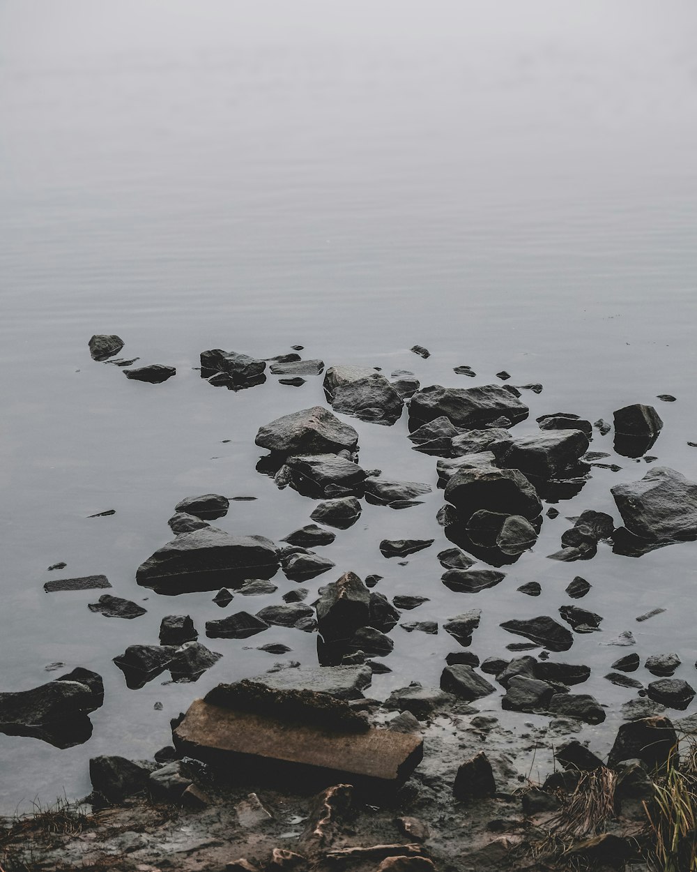 gray rocks on body of water