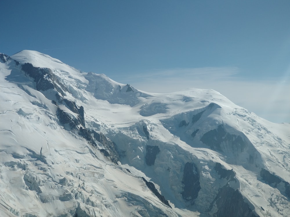 snow covered mountain under blue sky