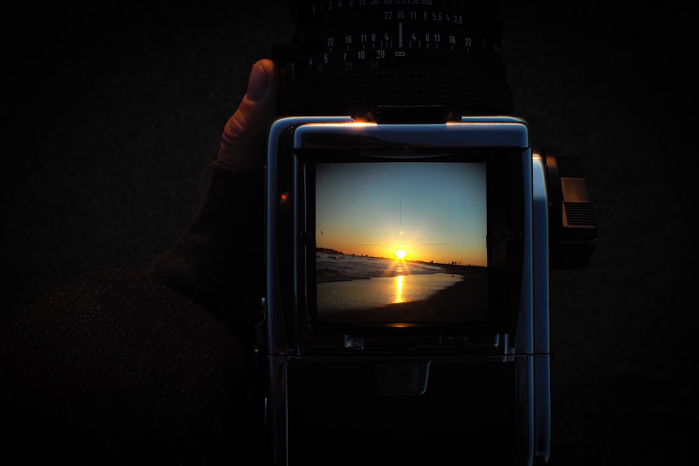 person holding blue framed monitor