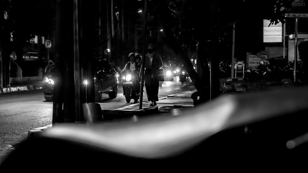 grayscale photo of man walking on street