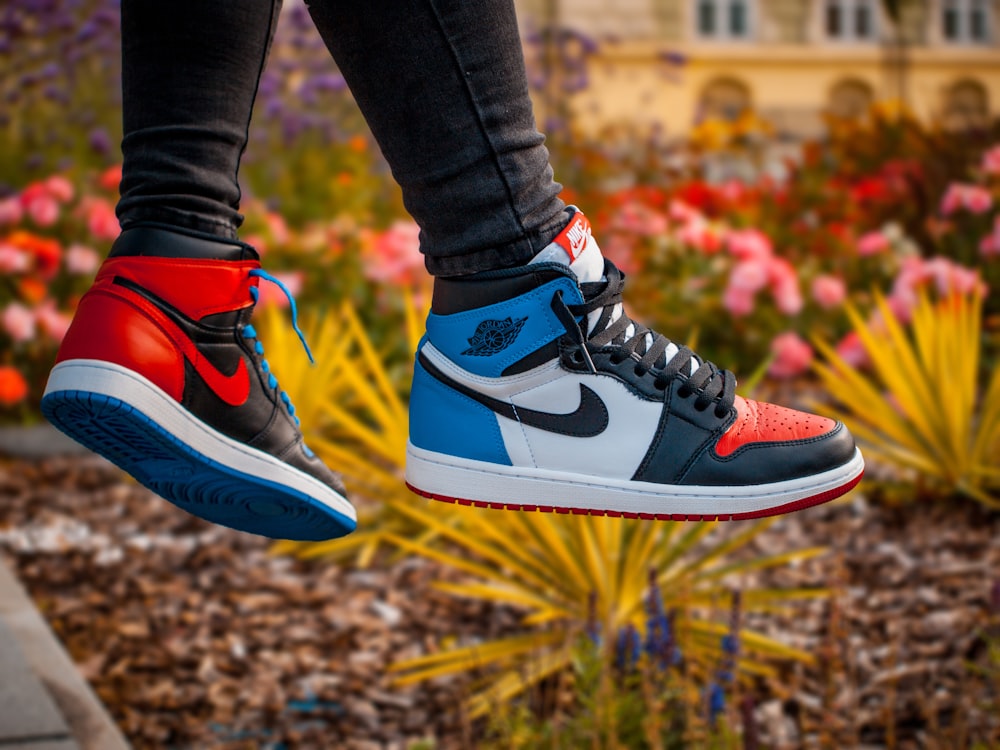 shallow focus photo of person wearing pair of top 3 Air Jordan 1's