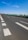 Image showing a freshly paved highway with clear markings under a bright sky.