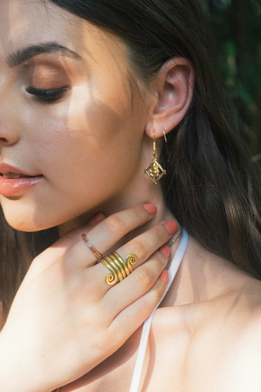 woman wearing gold-colored earrings