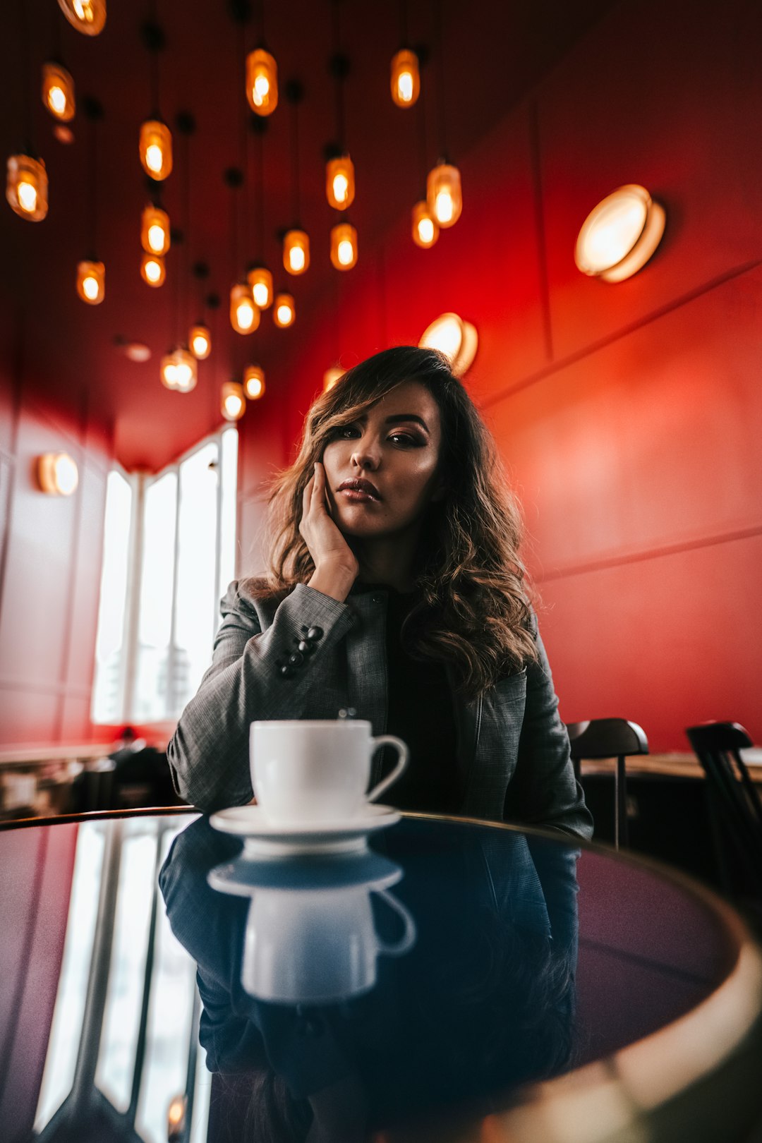 woman in gray long-sleeved top siting indoors