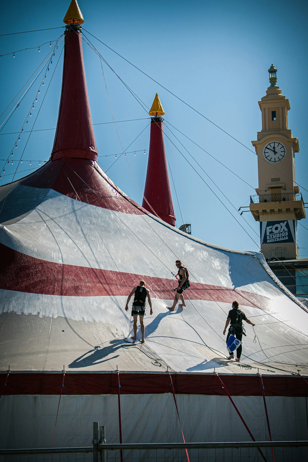 people standing on red, white, and grey tent