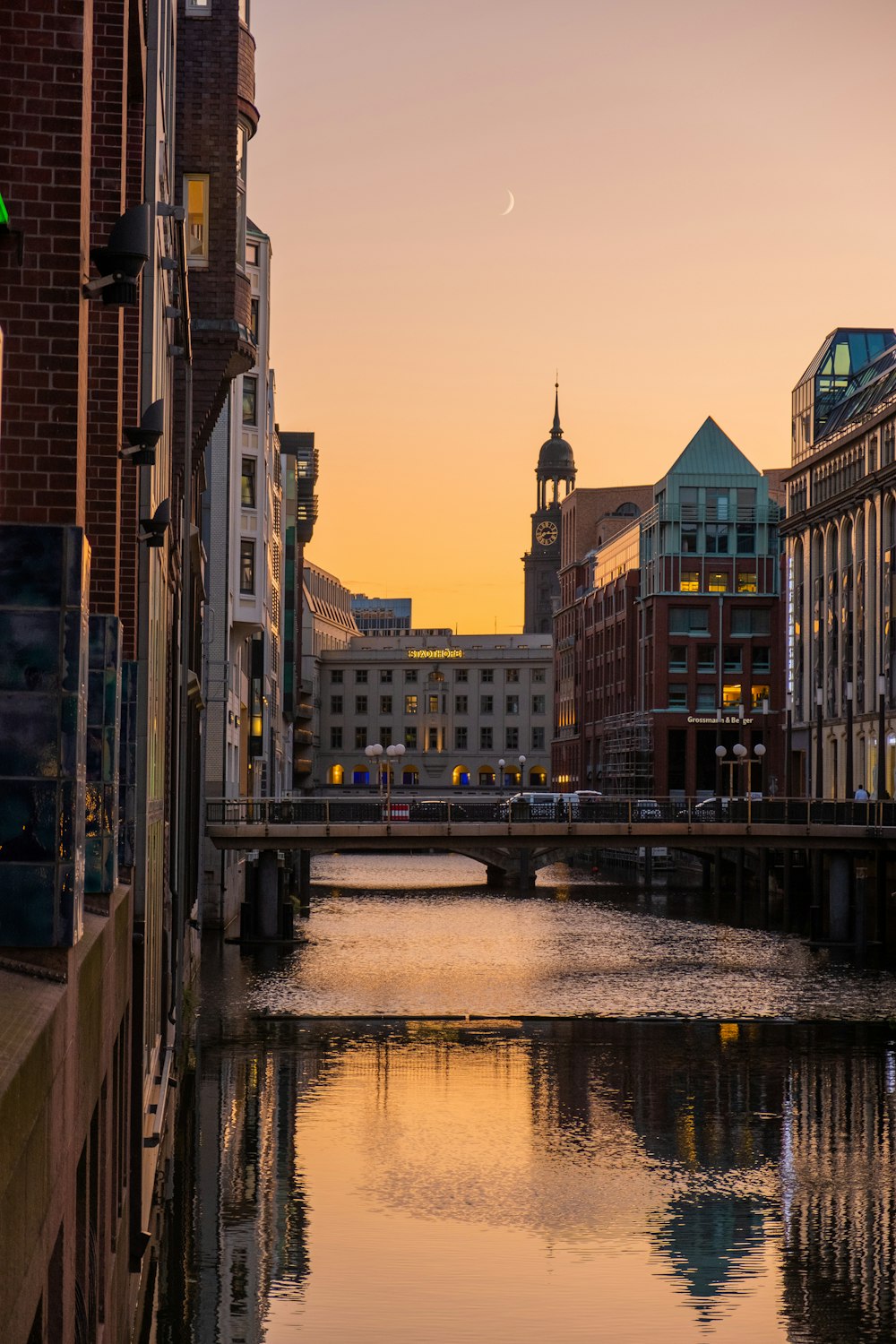 river surrounded by buildings under gray sky