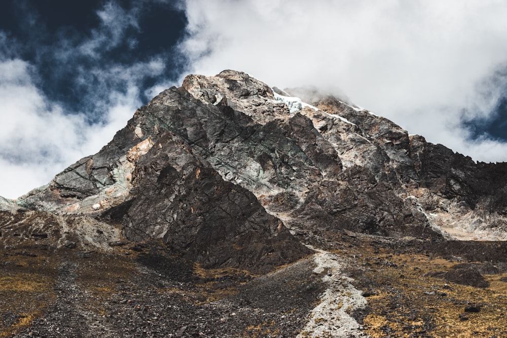 brown and gray mountain under white and blue sky during daytime