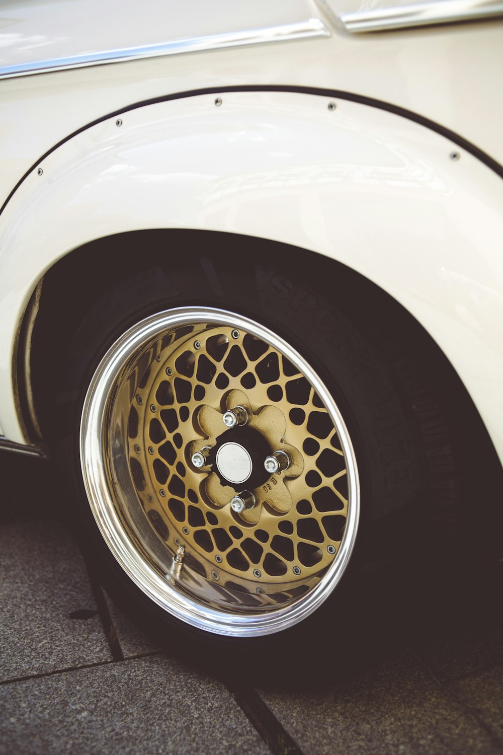 silver and gold car wheel with tire