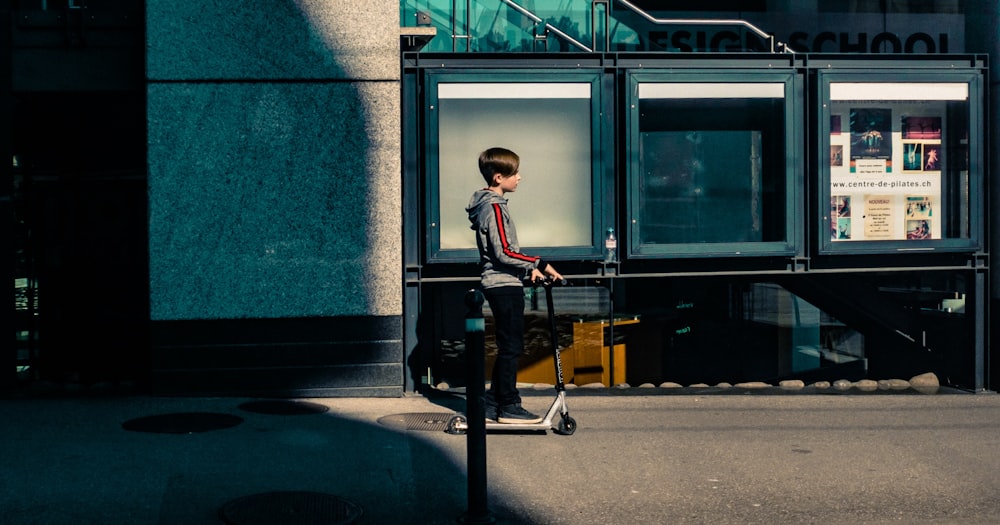 boy riding kick scooter