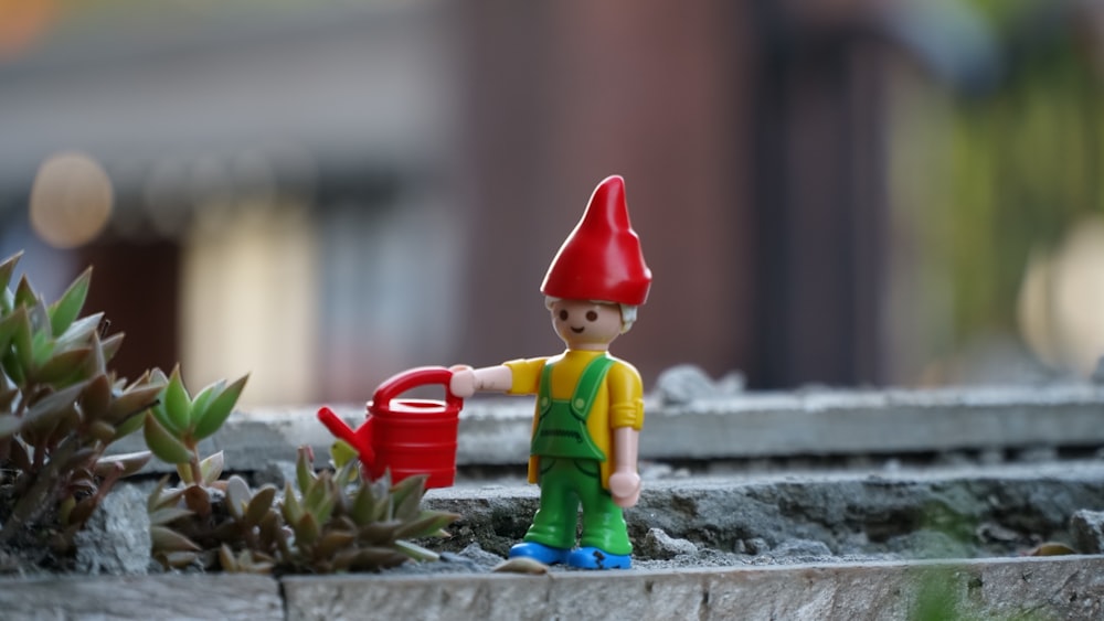 gnome holding watering can toy