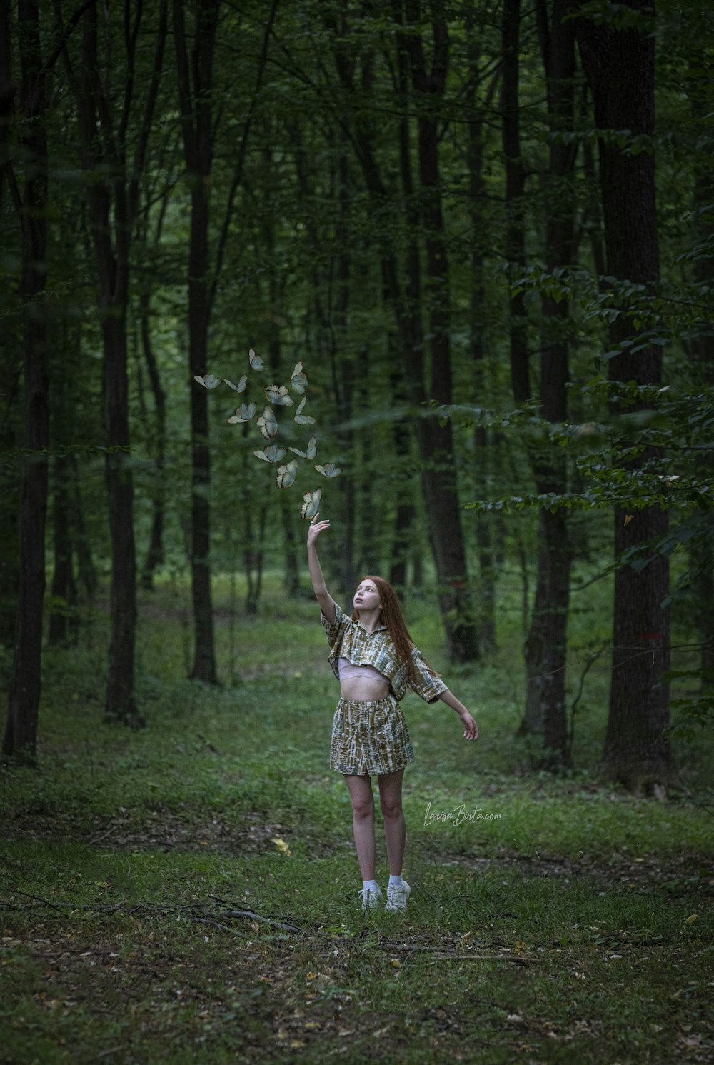 woman about to catch butterflies on forest