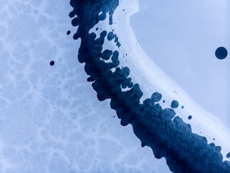 Macro photograph of ink layers under polarized light revealing alterations in a contract.