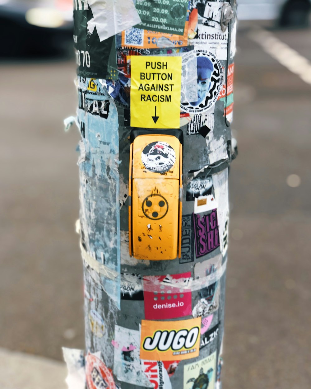 concrete post surrounded by posters