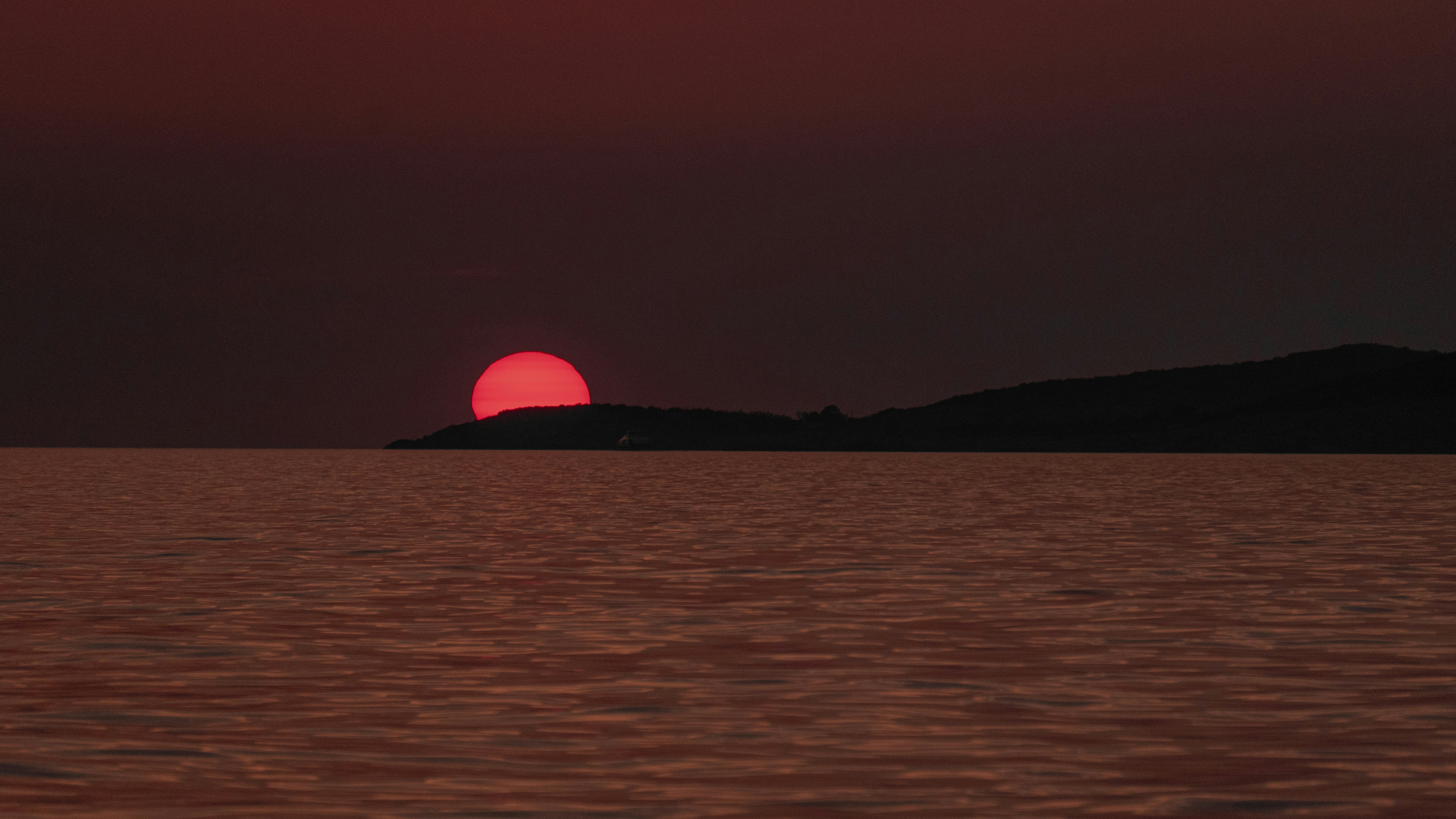 body of water viewing mountain during sunset