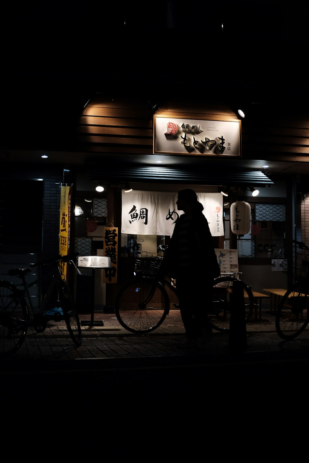 silhouette of woman walking on street