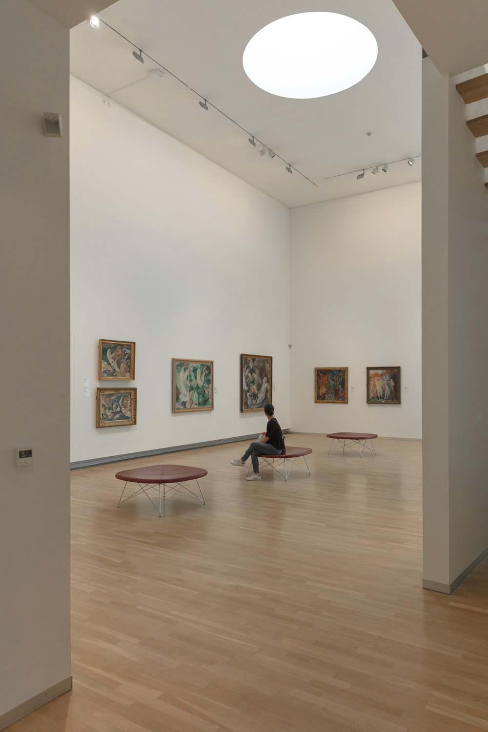 a person sitting on a bench in a museum