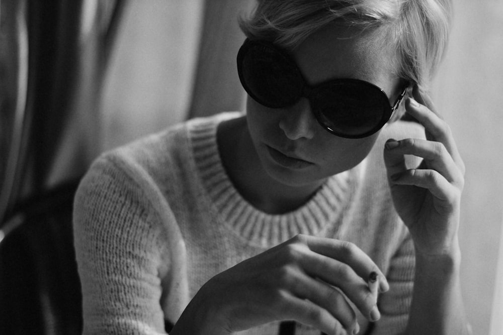 greyscale photo of woman wearing sunglasses