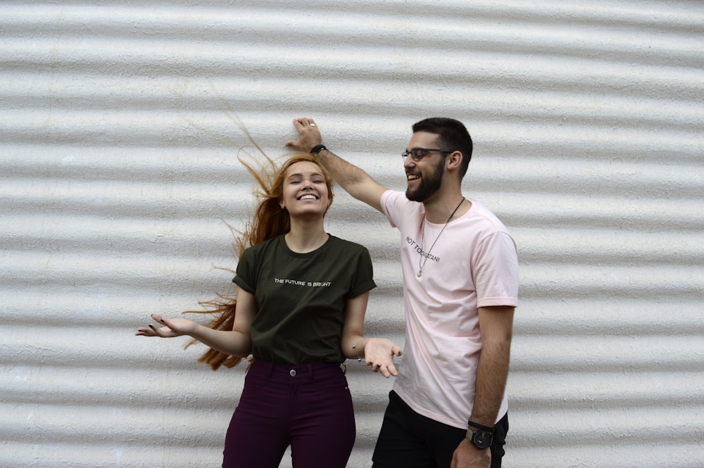 man and woman standing while chatting