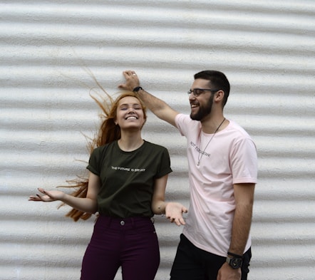 man and woman standing while chatting