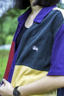 woman wearing multicolored Stussy jacket standing