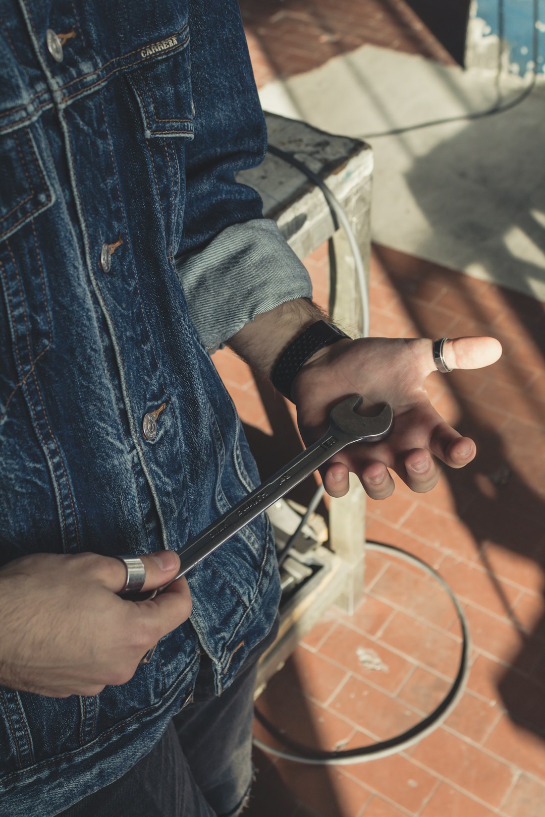 person holding wrench