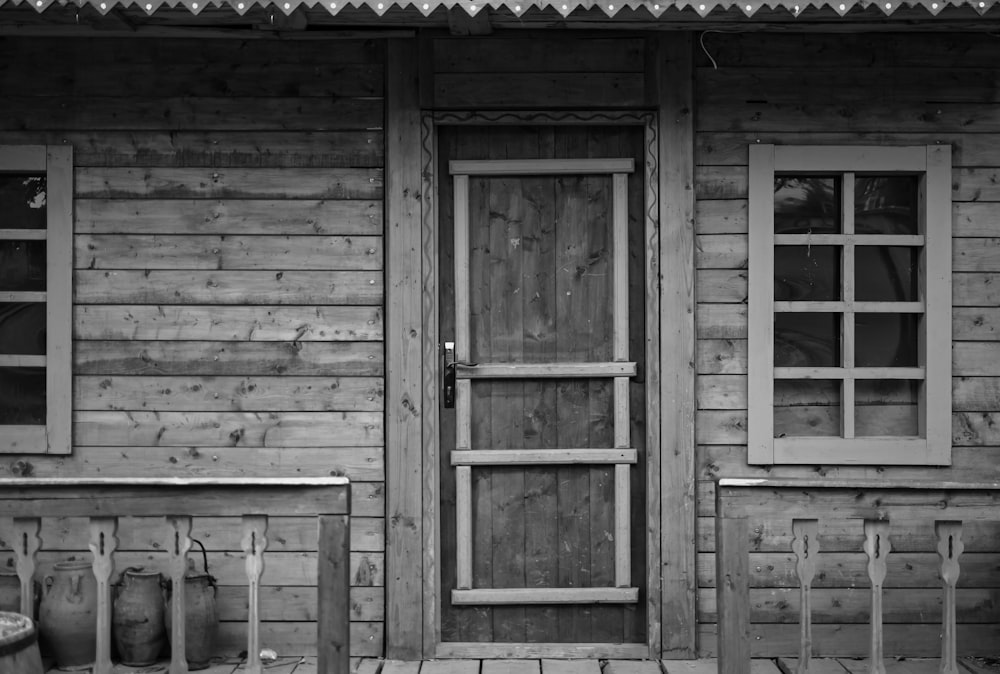 grayscale photo of closed door house