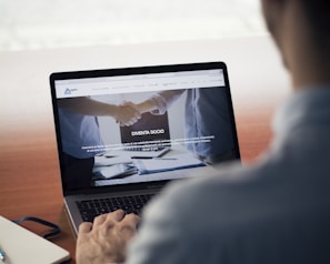 man operating the MacBook Pro