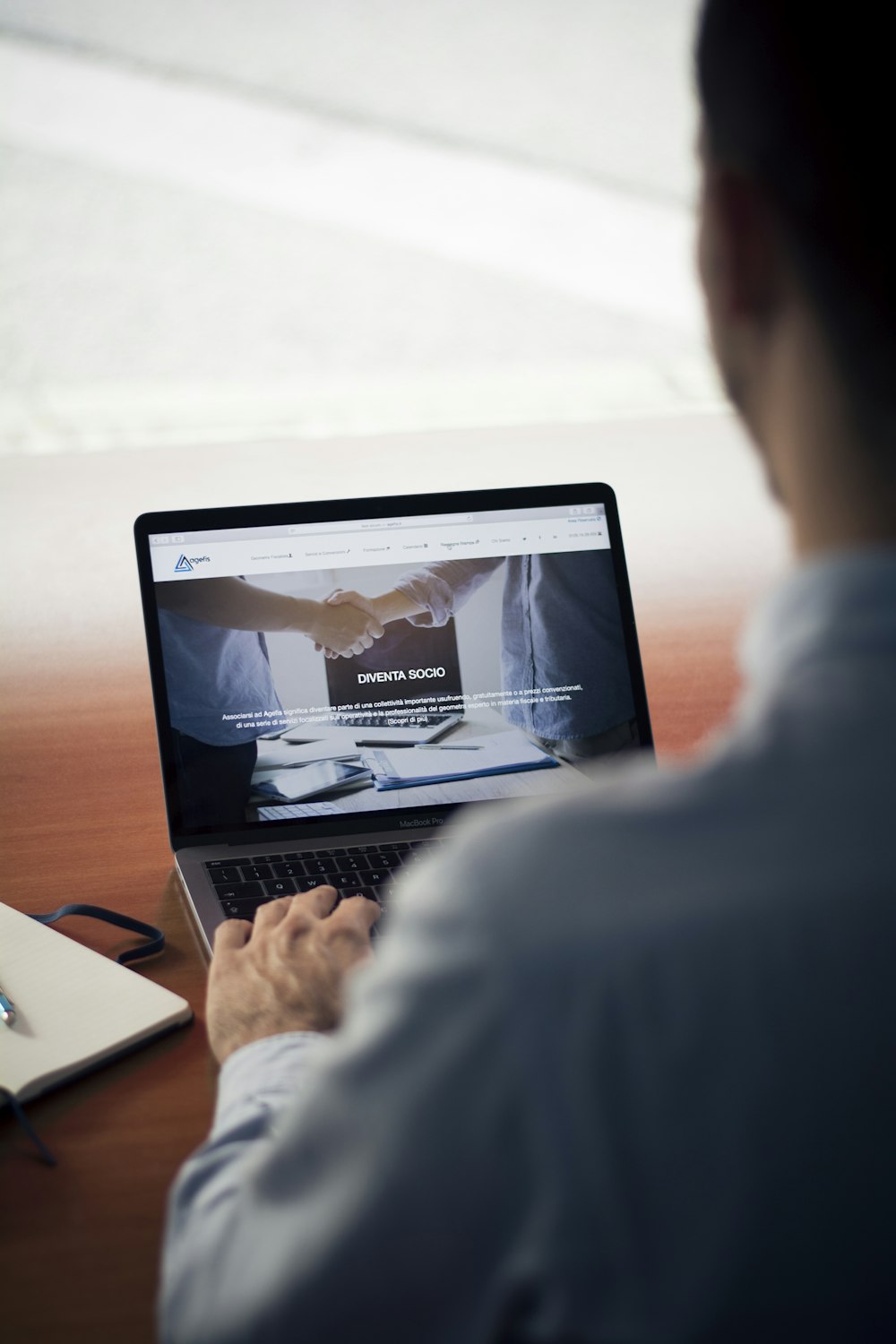 man operating the MacBook Pro