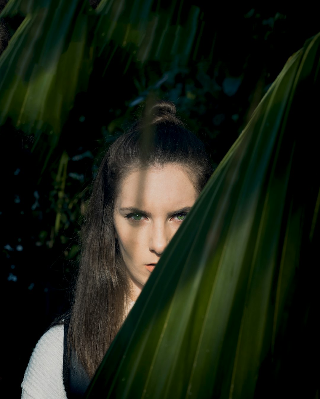 woman standing near green leaf