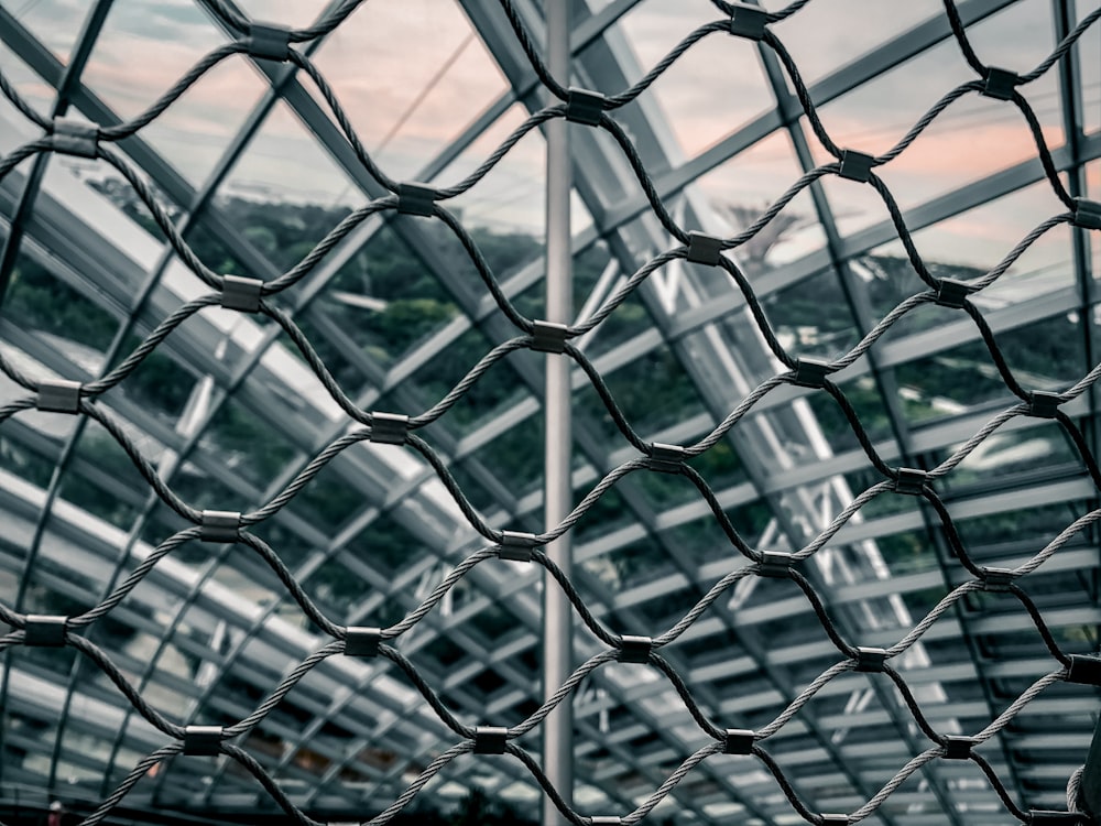 a chain link fence with a building in the background