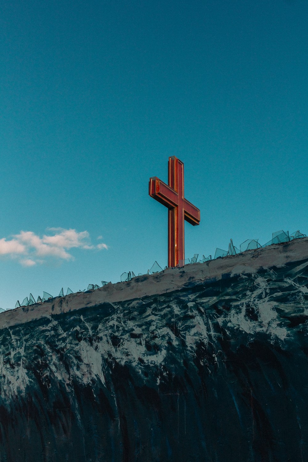 brown cross under blue sky