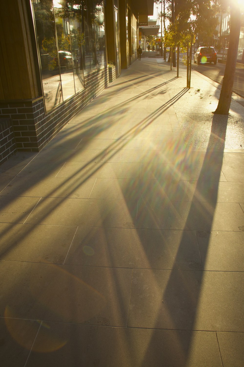 the sun is shining down on a city street