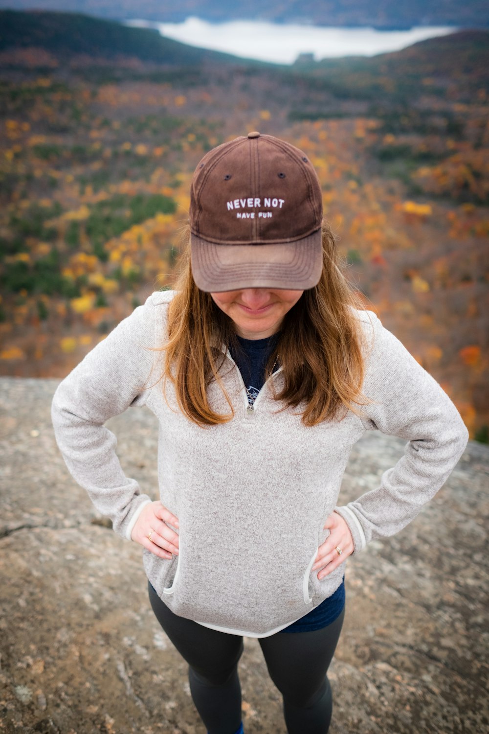 selective focus photo of woman standing on cliff