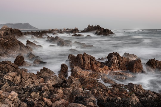 time lapse photography of waves splashing on rocks in Kleinmond South Africa