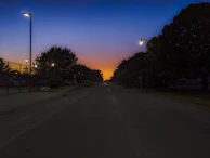 Sunset view over the peaceful streets of Countrywoods Heritage with street lamps lighting up