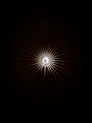 a black and white photo of a light in the dark