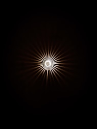 a black and white photo of a light in the dark