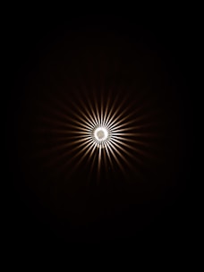 a black and white photo of a light in the dark