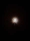 a black and white photo of a light in the dark