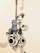 A decorative wall art featuring a stylized guitar with swirling patterns and abstract designs. Musical notes are included, adding to the creative and artistic theme.