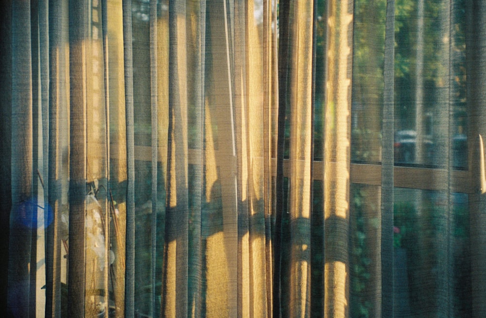 sunlight reflecting on yellow window curtain