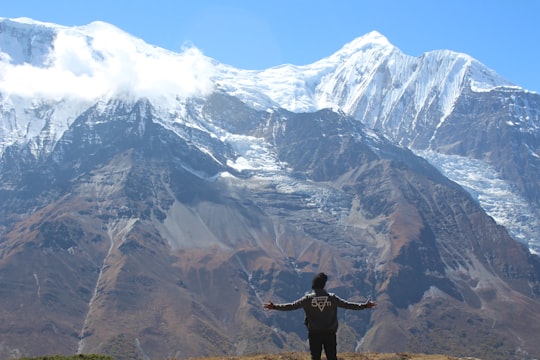 man standing near brown and white mountain in Manang Nepal